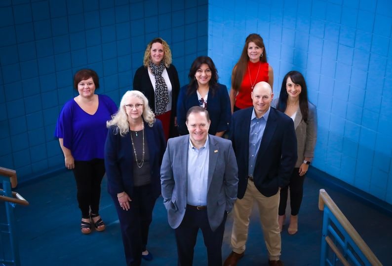 Chris Smith, the district’s chief financial officer, is in front. On the second row are, from left, Sharri Butterfield, director of budget & treasury and Jamey Hynds, executive director of finance. On the third row are Christy Alspaw, accounts payable manager; Gloria Truskowski purchasing & distribution executive director, and Kayla Smith, accounting director. On the fourth row are Kristi Grant, payroll director, and Terri Nelson, assistant to the chief financial officer.